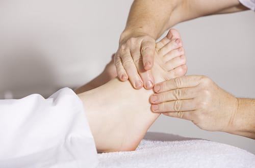 a person massaging someone's leg