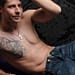 Man with out shirt showing the tattoo on her chest