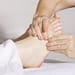 a person massaging someone's leg