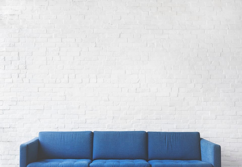 a blue couch with white background